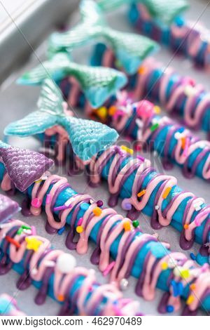 Mermaid Chocolate Pretzel Rods Drizzled With Pink And Purple Chocolate And Covered With Sprinkles.