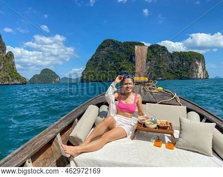 Woman Tourist In Private Longtail Boat Trip To Island With Exotic Food Picnic, Krabi, Thailand. Land