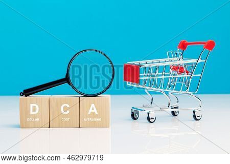 Magnifying Glass And Dca Word On A Wooden Cube In Idea Dollar Cost Averaging Investment Strategy Nea