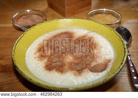 A Plate Of Porridge, Applesauce, And Cinnamon And Sugar.