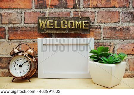 Empty Photo Frame Mock Up With Welcome Sign And Artficial Plant Home Decoration