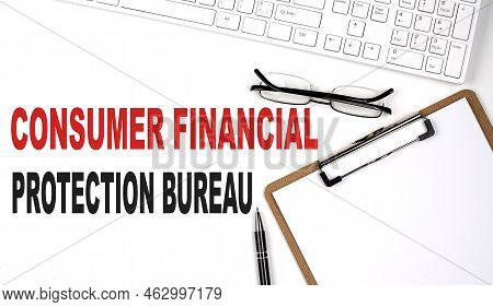 Consumer Financial Protection Bureau Text Written On White Background With Keyboard, Paper Sheet And