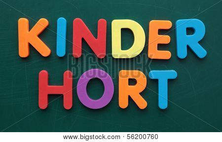 German term for day care center in colorful letters on a blackboard.