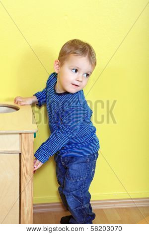 Cute caucasian toddler playing in kindergarten.