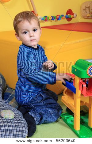 Single kid playing in kindergarten.