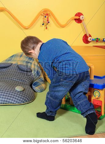 Single kid playing in kindergarten.