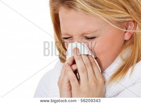 Attractive teenage girl using tissue. All on white background.