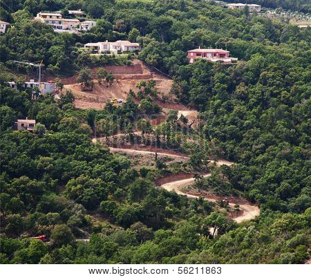 Serpentines road works on mountainside.
