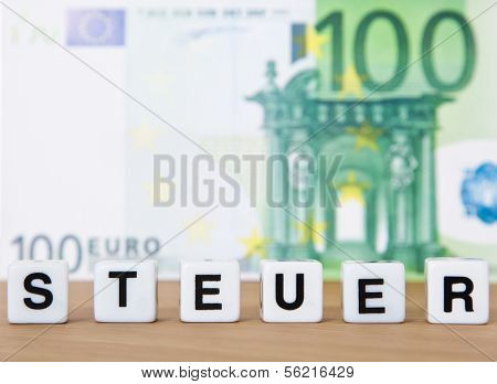 The german term Steuer (engl. tax) in front of 100 euro note