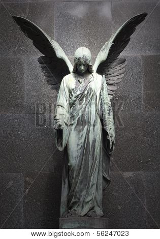 sculpture of an angel with dark background