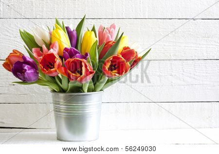 Spring easter colorful tulips on white vintage background planks