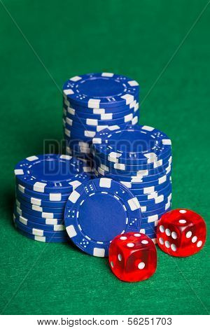 Blue Poker Chips And Two Cubes On The Green Table