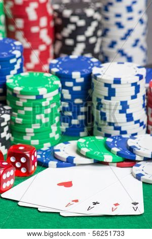 Dice, Four Aces And Chips On A Green Felt