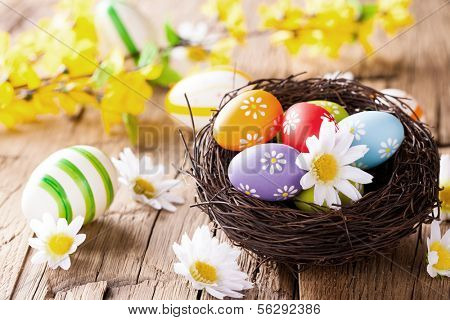 Easter still life with traditional decorative colored eggs in nest