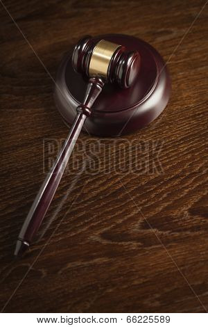 Dark Wooden Gavel Abstract on Table with Room for Text.