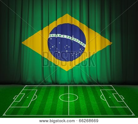 Soccer field with flag of Brazil on green curtain