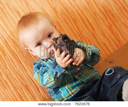 Boy Plays With Gun