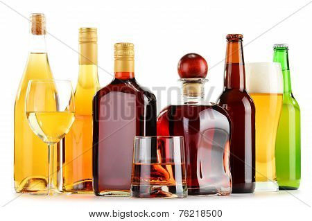 Bottles And Glasses Of Assorted Alcoholic Beverages Over White