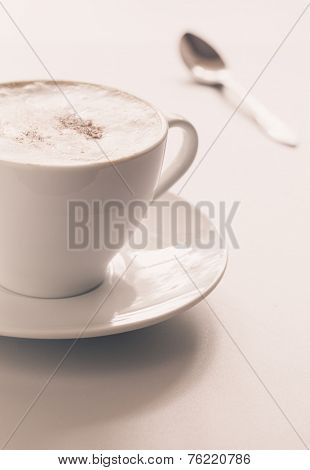 Cappuccino cup on a light background. Shallow depth of field