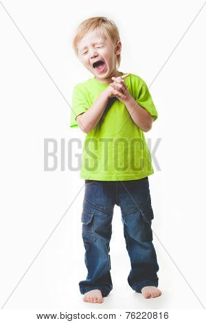Blonde boy, 4 years old, full-length portrait, without shoes. Uniform light gray background.