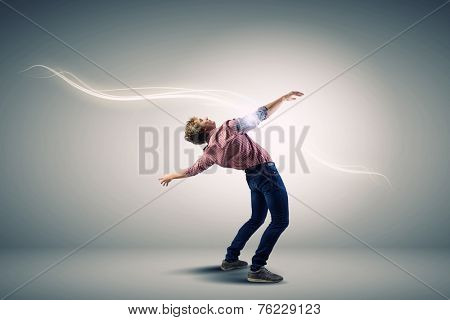 Young guy in casual evading from light rays