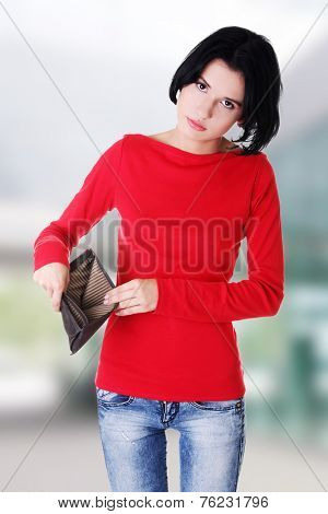Young woman shows her empty wallet. Bankruptcy concept