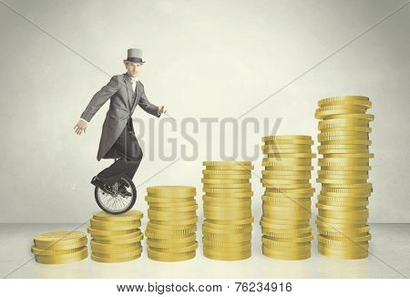 Business man riding monocycle up on coin graph concept on background