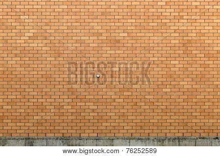 Somewhat clean exterior brick wall with a rather dirty concrete foundation.