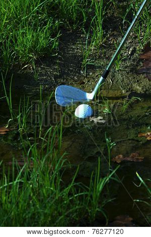Man chipping ball from water hazard