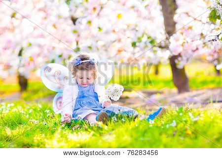 Little Girl In Blooming Garden