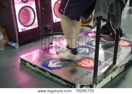 LONDON UK - NOVEMBER 15: Legs of participants playing dancing video game in Hyper Japan. November 15, 2014 in London. Held in Kensington Olympia this year, the event celebrates all things Japanese.