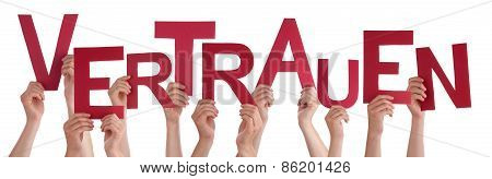 People Holding German Word Vertrauen Means Trust