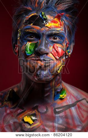 A creepy portrait of halloween moor with colour body art.