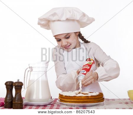 Cooking and people concept - smiling little girl in cook hat, isolated on white background