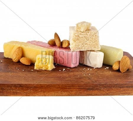 marzipan with almonds on wooden board close up isolated on white background