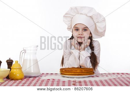 Cooking and people concept - smiling little girl in cook hat, isolated on white background
