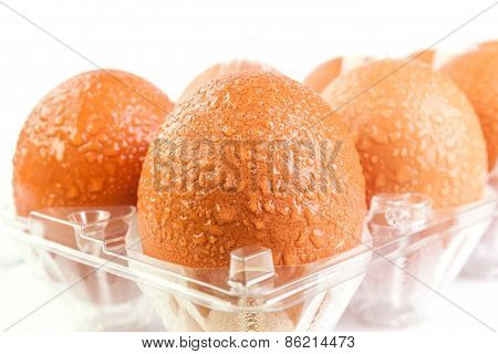 Brown Eggs And Water Drops In Plastic Package After Refrigerator On White Background.