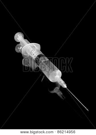 Syringe For Injections On A Black Background.
