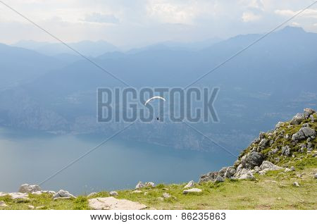 Paraglider Is Flying In Front Of Mountain Landscape Of Alps - Monte Baldo