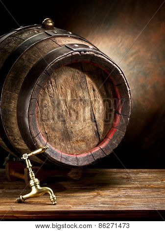 Old oak wine barrel on wooden table.