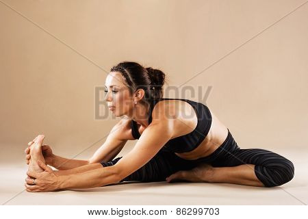 Sporty woman is doing yoga asana