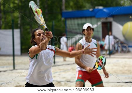 MOSCOW, RUSSIA - JULY 15, 2015: Selma Hidass (left) and Adil Medina of Morocco in action during the ITF Beach Tennis World Team Championship. Morocco first time competes in the event