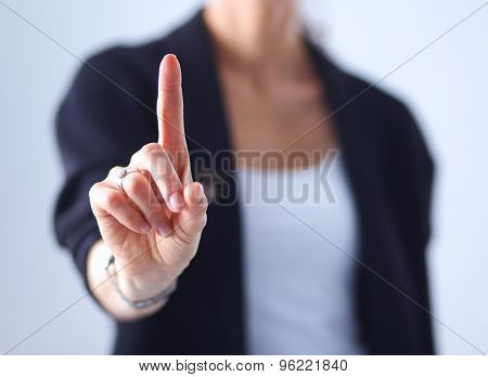 Woman touching an imaginary screen with her finger 