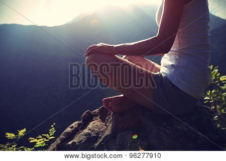 young yoga woman sit meditation on sunrise mountain peak