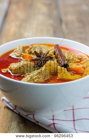 Top View, Pork Mussaman Curry On Wood Background