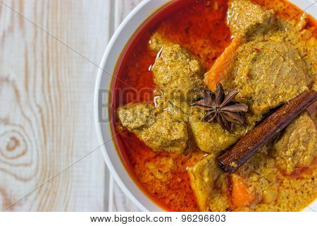 Top View, Pork Mussaman Curry On Wood Background