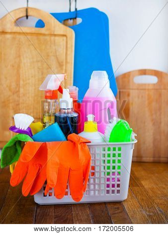 Basket With Cleaning Items On Blurry Background White Citchen. Cleaning Concept.