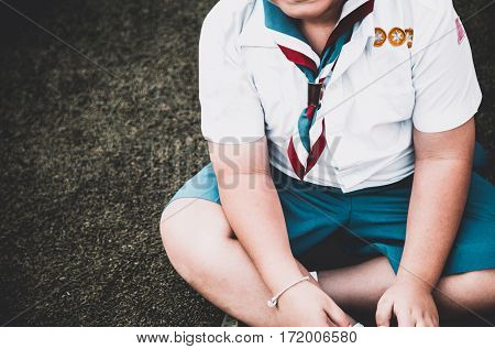 Group Of Asian Boy Scout Sitting On Greensward For Relax Time. Asia Boy Scout General Uniform Concep