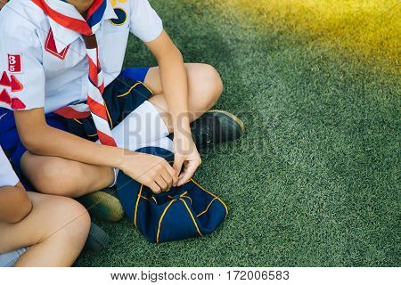Group Of Asian Boy Scout Sitting On Greensward For Relax Time. Asia Boy Scout General Uniform Concep