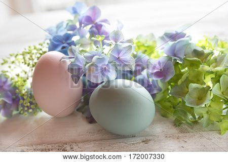 Easter decoration in tender colors on a white shabby wooden table